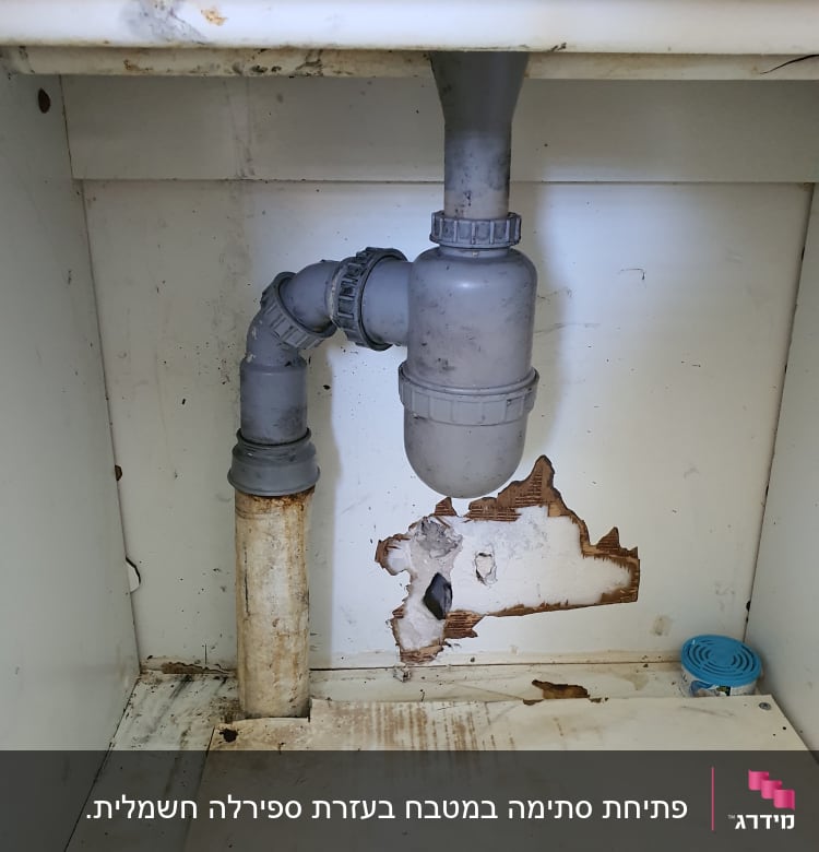 צינור ביוב מתחת לכיור עם נזילה בקיר